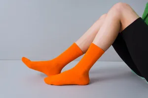 Vibrant orange ribbed mid-tube socks for women, stylish everyday casual hosiery wear detail.