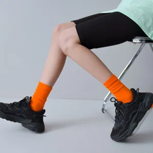 Vibrant orange ribbed mid-calf socks for women, trendy casual streetwear hosiery for daily wear.