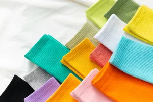 Colorful ribbed mid-tube socks detail shot, soft cotton candy colors, stylish everyday wear.
