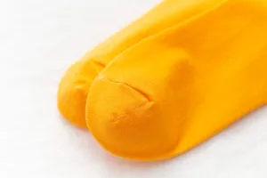 Close-up detail shot of bright yellow candy color cotton slouchy mid-tube socks texture.