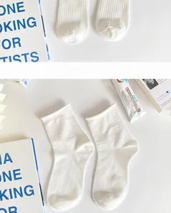 Detail view of white mid-tube women socks, clean Japanese cute style daily wear essential.