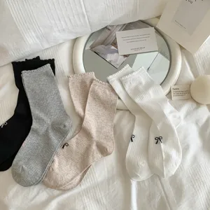 Close-up of Japanese style ruffle bow mid-tube cotton socks featuring cute details for daily wear.