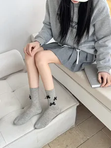 Sweet Lolita grey mid-calf socks for women, featuring cute black bows for daily casual wear.