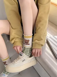 Cute women cotton mid-tube socks with cute bear and green grid design for summer daily wear.