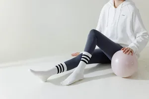 White yoga socks detail view featuring classic striped design, perfect for pilates and fitness workouts.