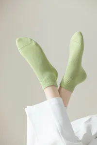 Nahaufnahme von hellgrünen, atmungsaktiven Netz-Baumwoll-Kurzsocken für Damen, weich und bequem.