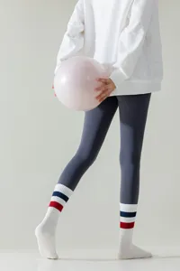 Detail shot of women's athletic long socks with vintage striped design for fitness and yoga.