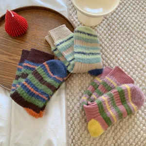 Cozy striped fuzzy mid-calf socks detailed view showing soft plush texture and colorblock design.
