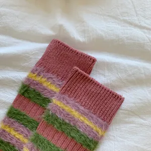 Detailed shot of soft fluffy knit stripe socks, cozy winter warm colorful retro mid tube style.