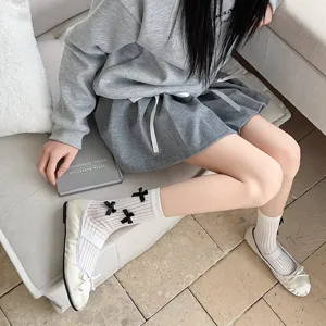 Detail of sweet Japanese white mid-tube socks with cute black bows for Lolita daily wear.