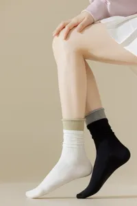Detailed view of women's double-ribbed colorblock mid-calf socks showcasing daily casual wear.