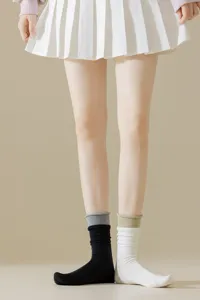 Detail view of contrast ribbed mid-tube socks with fake two-piece design showing texture.