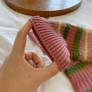 Close-up of fuzzy striped knit mid-tube socks, soft texture and cozy autumn winter sock detail.