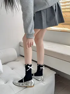 Cute black ruffle socks with white bowknot details, perfect for Lolita and daily sweet styles.