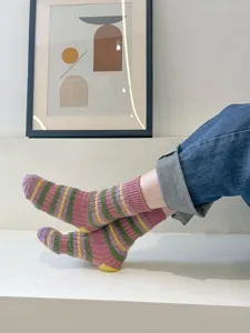 Close-up detail of cozy fuzzy striped women's mid-calf socks in soft color block design.