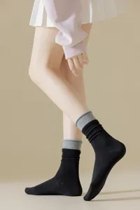 Close-up detail of women's contrast color crew socks featuring stylish double ribbed cuffs.
