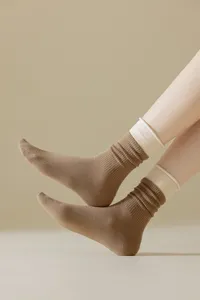 Close-up detail of women mid-calf socks with contrast color ribbed design for daily wear.
