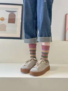 Fuzzy striped mid-tube women socks detail view, cozy winter retro thermal design style.