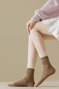Detail view of women's contrast fake two-piece mid-tube socks featuring double ribbed cuff.