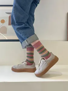 Detail shot of cozy plush striped mid-calf women socks in sweet retro style for autumn winter.