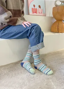 Detailed view of cozy Korean style fluffy striped women socks, soft autumn winter warm wear.