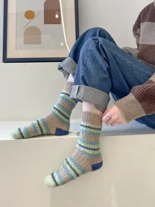 Cozy fuzzy striped mid-tube socks detail shot, soft warm winter knitwear style for women.