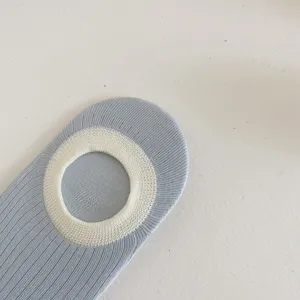 Detail view of women's light blue contrast boat socks with white ribbed collar for summer.
