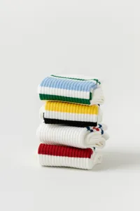 Detailed view of folded white cotton striped yoga socks for women, neat stack presentation.