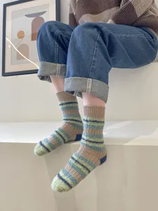Detail view of cozy fuzzy striped mid-calf socks, perfect for autumn and winter warmth.