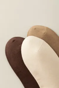 Close-up detail showing the smooth knit texture and multi-color layered design of women's socks.