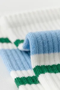 Detailed close-up shot of striped knit yoga socks showing soft texture and elastic ribbed fabric.