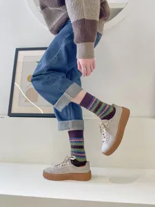 Cozy striped fuzzy socks for women, thick stripe design, soft and warm winter wear.