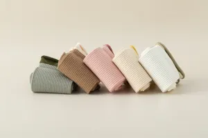 Detailed close-up view of rolled ribbed women socks in assorted soft pastel and neutral colors.