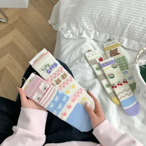 Cute cotton mid-tube socks for women with lovely cartoon patterns and soft breathable fabric.