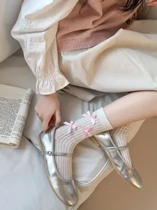 Sweet Japanese style mid-calf socks featuring delicate pink bows, paired with shiny silver shoes.