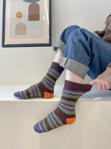 Fuzzy striped women's mid-tube socks detail shot showing colorful winter warm knit design texture.
