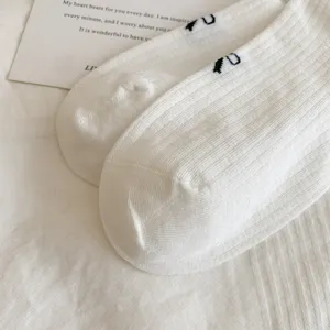 White cotton mid tube socks for women, cute bow knit design, simple Japanese style casual wear.