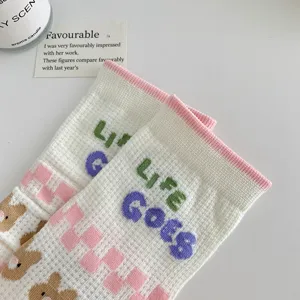 Detailed view of cute cartoon mid-calf socks featuring breathable mesh cotton and bear patterns.