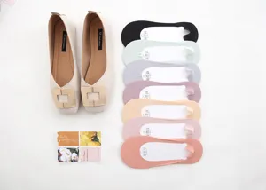 Close-up detail of women's beige flat shoes and colorful invisible boat socks set.