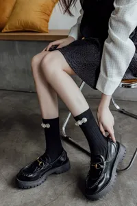 Calze al polpaccio Lolita nere decorate con perle eleganti e abbinate a scarpe platform alla moda.