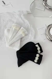 Dettaglio calzini Lolita giapponesi con perle, eleganti calze arricciate bicolore.