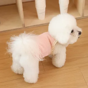 Detailed shot of a breathable pink knit pet vest with lace trim, displayed on a small dog.