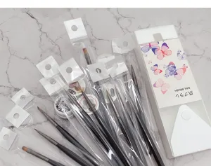 Portable 12pcs nail art brush set with storage box and clear sleeves for professional use.