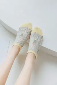 Mesh floral boat socks detail view, breathable summer ankle socks with yellow toe and cuff.