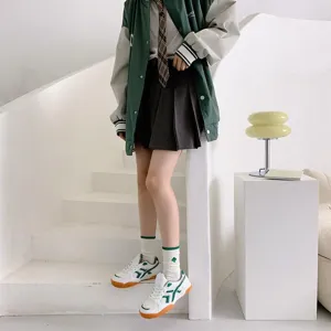 Green striped mid-tube socks shown in detail, Japanese college style cute fashion autumn wear.