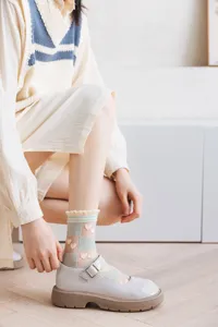 Close-up detail shot of Japanese style grid sheer socks featuring cute heart patterns.