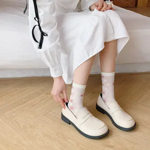 Detail view of sweet Japanese style white mid-calf socks with cute bow floral prints.