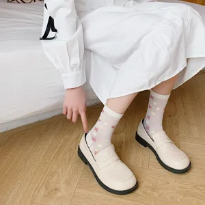 Detailed close-up of cute Japanese style sheer mid-calf socks with bows for spring summer.