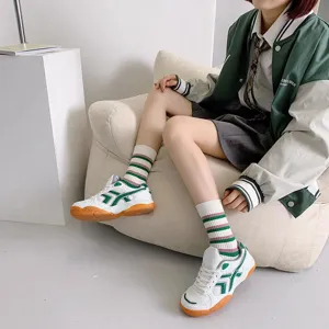 Green striped mid-tube socks paired with Japanese college style outfit for women, stylish and chic.