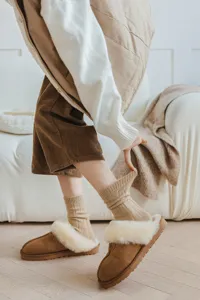 Cozy knit wool socks paired with plush slippers for women, vintage autumn winter warm leg wear.